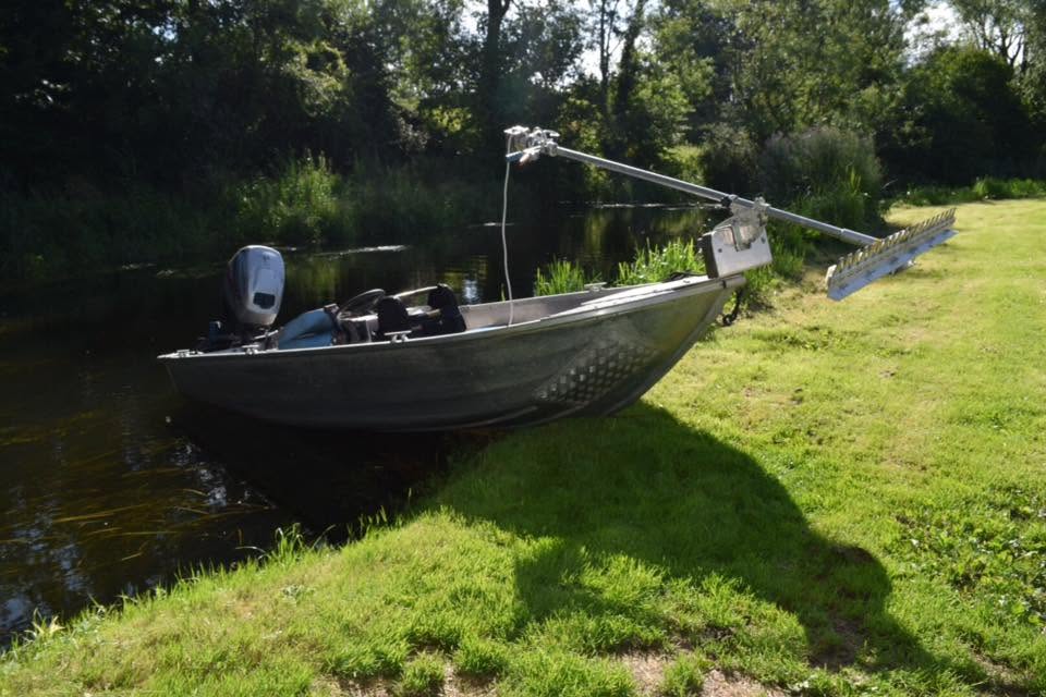 Weed-cutting boat on the river